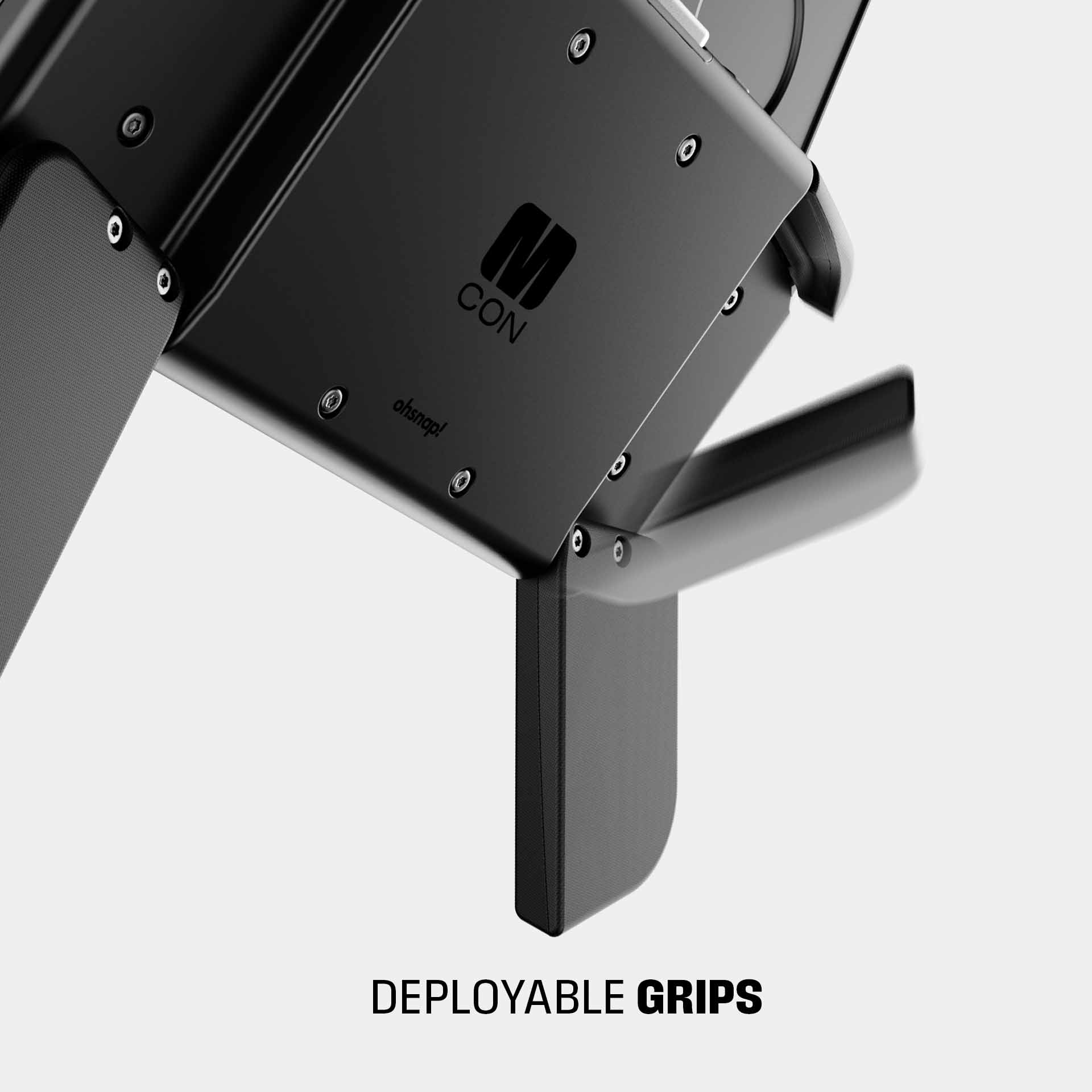 Close-up of a black device featuring deployable grips and the "M CON" logo.